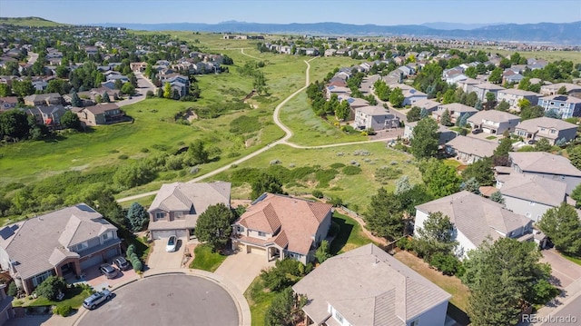 10085 Charissglen Ct, Highlands Ranch, CO 80126 - aerial view of property and surrounding area featuring nearby suburban area and a mountain backdrop