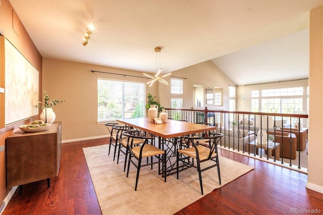 10085 Charissglen Ct, Highlands Ranch, CO 80126 - dining area with healthy amount of natural light, wood finished floors, and vaulted ceiling