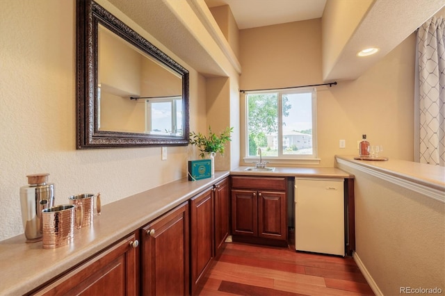 10085 Charissglen Ct, Highlands Ranch, CO 80126 - bar with a sink and light wood-type flooring