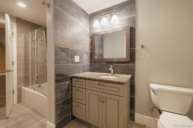 10085 Charissglen Ct, Highlands Ranch, CO 80126 - bathroom with tile walls, vanity, and shower / bath combination with glass door