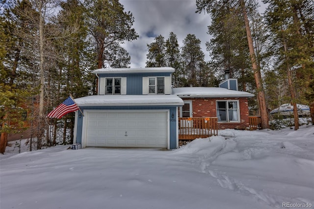 view of front facade featuring a wooden deck and a garage