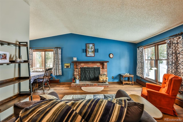 living room featuring a fireplace, hardwood / wood-style floors, a textured ceiling, and vaulted ceiling