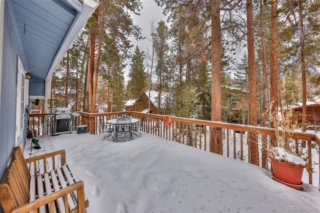 snow covered deck featuring a grill