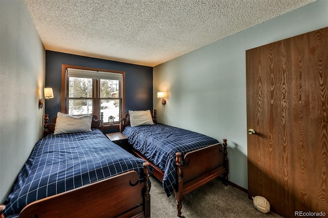 carpeted bedroom featuring a textured ceiling