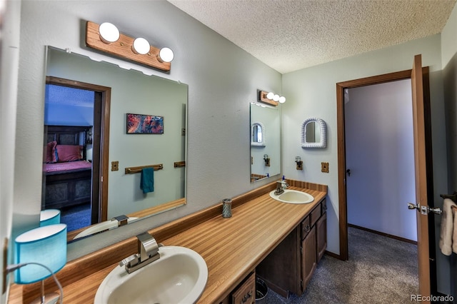 bathroom with vanity and a textured ceiling