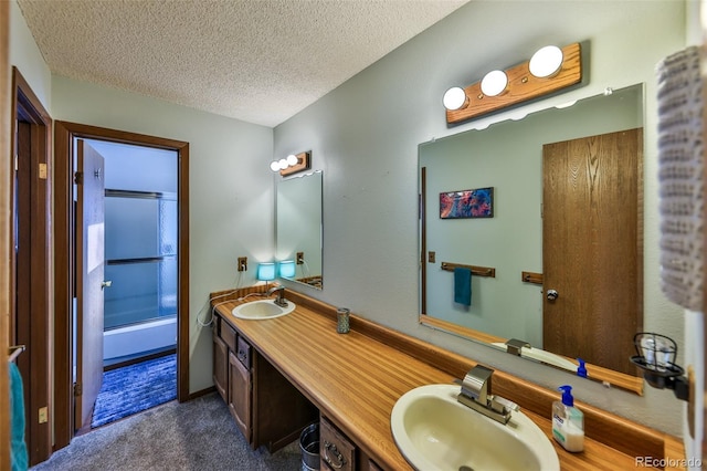 bathroom featuring vanity, shower / bathtub combination, and a textured ceiling