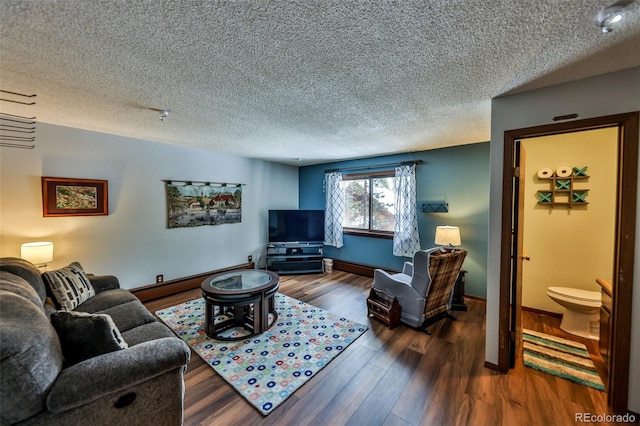 living room with a textured ceiling, dark hardwood / wood-style floors, and baseboard heating