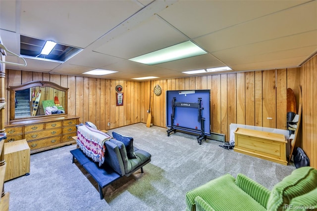 living area with a paneled ceiling and light carpet