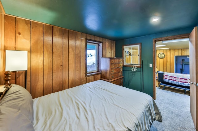 bedroom with carpet flooring and wooden walls