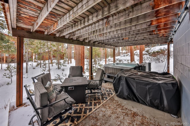 snow covered patio with a hot tub