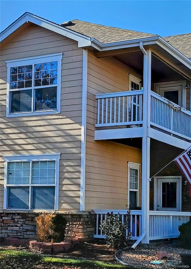 view of side of property featuring a balcony