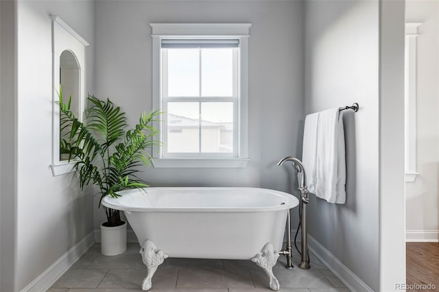 bathroom featuring tile patterned flooring and a washtub