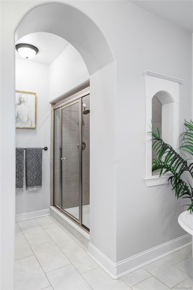 bathroom featuring tile patterned floors and a shower with door