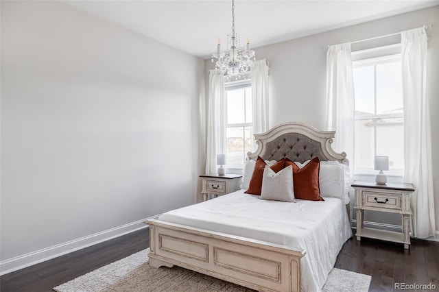 bedroom with a chandelier and dark hardwood / wood-style floors