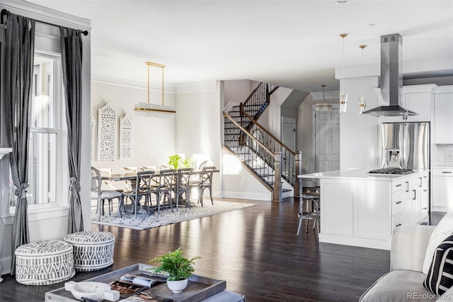 living room with crown molding and dark wood-type flooring