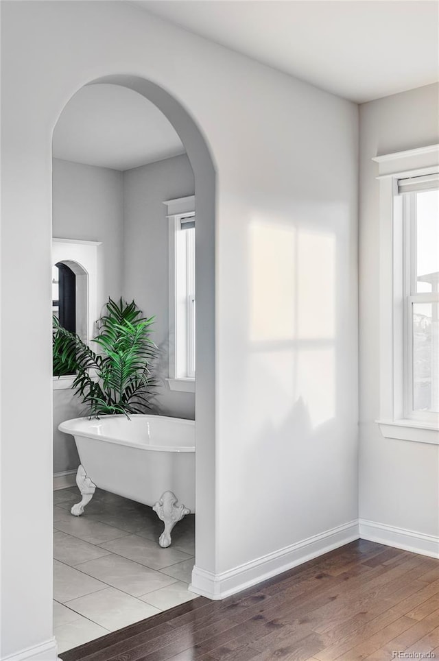 interior space with hardwood / wood-style floors and a bathing tub