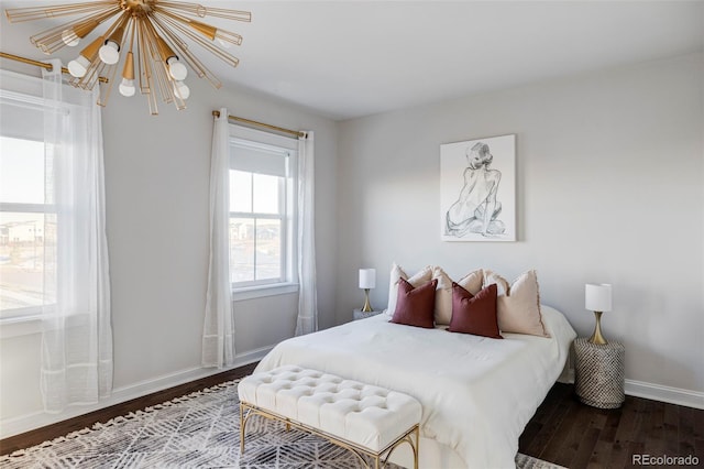 bedroom with hardwood / wood-style floors and a notable chandelier