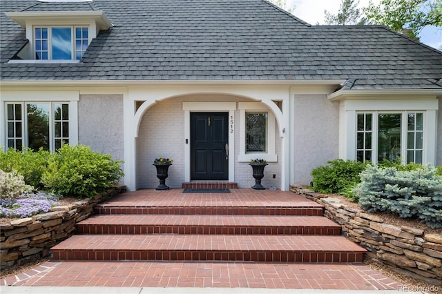 entrance to property featuring stucco siding