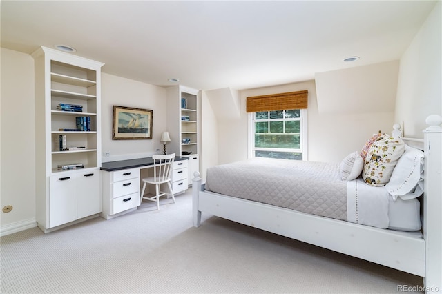 bedroom with light carpet and baseboards