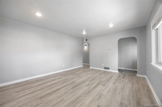 1560 Pueblo Ct, Thornton, CO 80229 - empty room featuring arched walkways, light wood-type flooring, recessed lighting, and baseboards