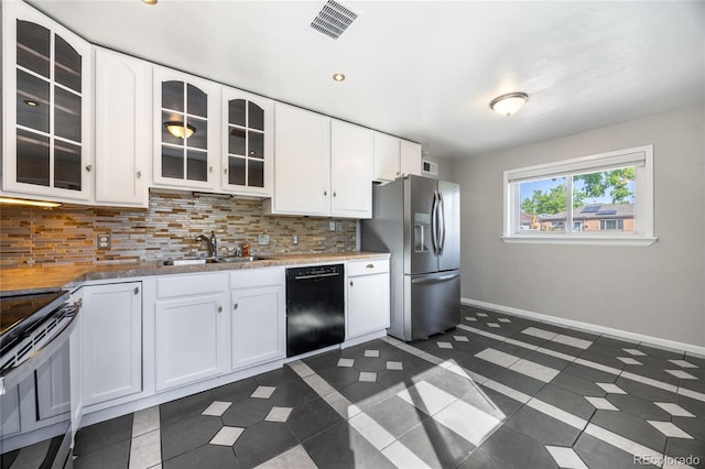 1560 Pueblo Ct, Thornton, CO 80229 - kitchen with stainless steel appliances, a sink, baseboards, backsplash, and white cabinetry