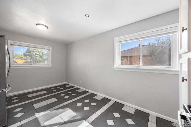 1560 Pueblo Ct, Thornton, CO 80229 - spare room featuring tile patterned flooring and baseboards