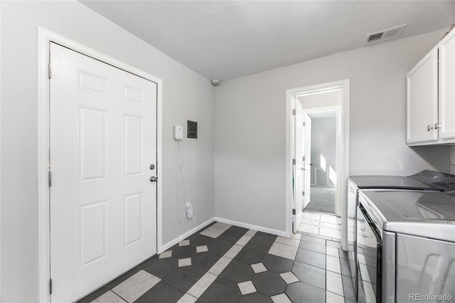 1560 Pueblo Ct, Thornton, CO 80229 - washroom featuring cabinet space, independent washer and dryer, baseboards, and dark tile patterned floors