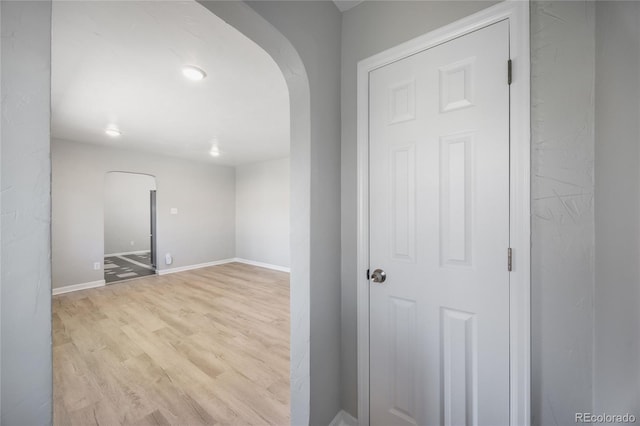 1560 Pueblo Ct, Thornton, CO 80229 - unfurnished room with arched walkways, wood finished floors, and baseboards