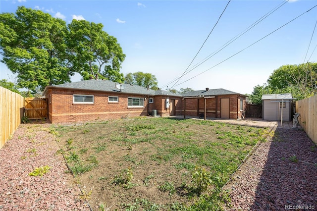 1560 Pueblo Ct, Thornton, CO 80229 - back of house featuring brick siding, a fenced backyard, a patio, and central AC
