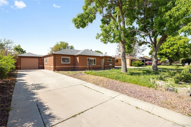 1560 Pueblo Ct, Thornton, CO 80229 - ranch-style house featuring concrete driveway, brick siding, an attached garage, and an outbuilding
