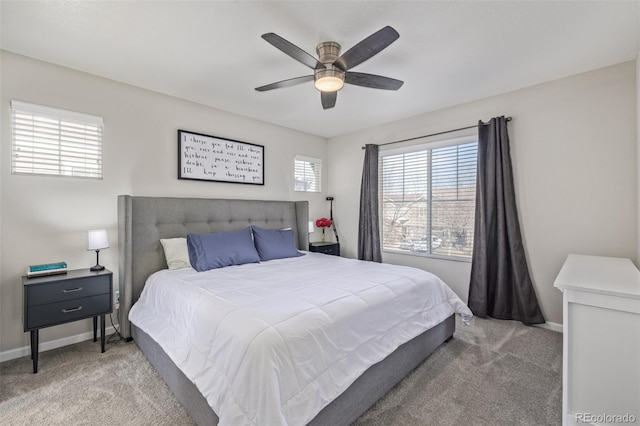 carpeted bedroom featuring ceiling fan and baseboards