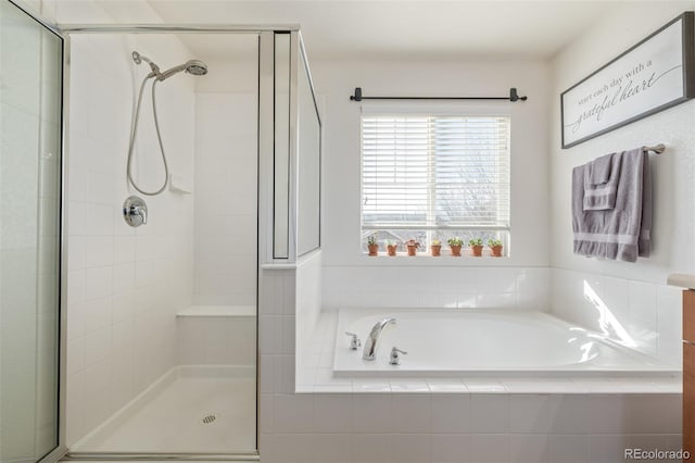 full bath with a stall shower and a garden tub