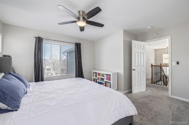 carpeted bedroom featuring baseboards and a ceiling fan