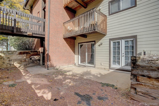 exterior space featuring french doors, a balcony, and a patio