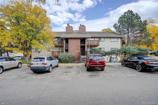 14602 E 2nd Ave Unit 100C, Aurora, CO 80011 - townhome / multi-family property with uncovered parking, a chimney, and brick siding