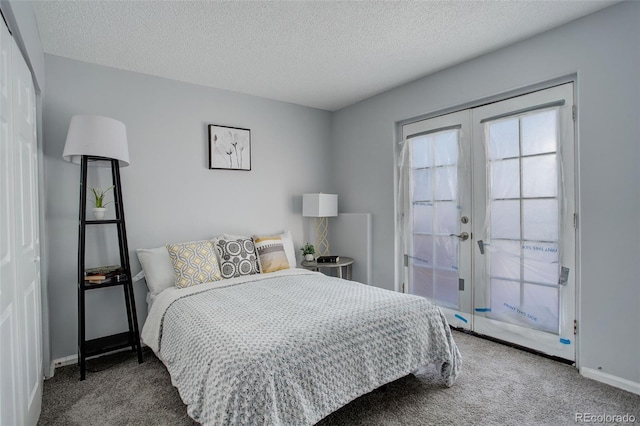 carpeted bedroom featuring a textured ceiling, french doors, and a closet