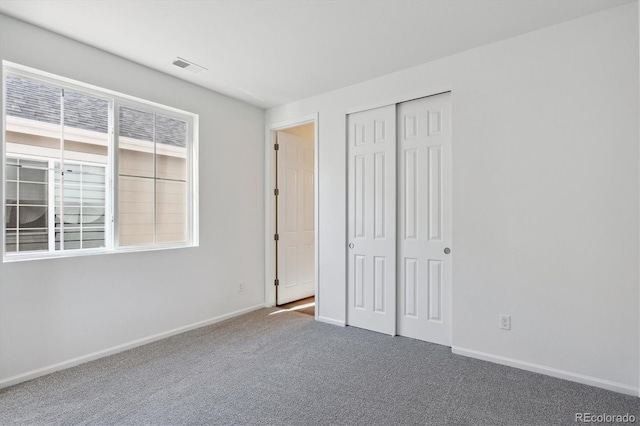 unfurnished bedroom featuring a closet and carpet floors