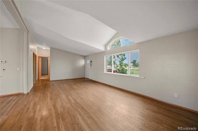 5520 Coyote Ln, Peyton, CO 80831 - unfurnished living room with vaulted ceiling and light wood-style flooring