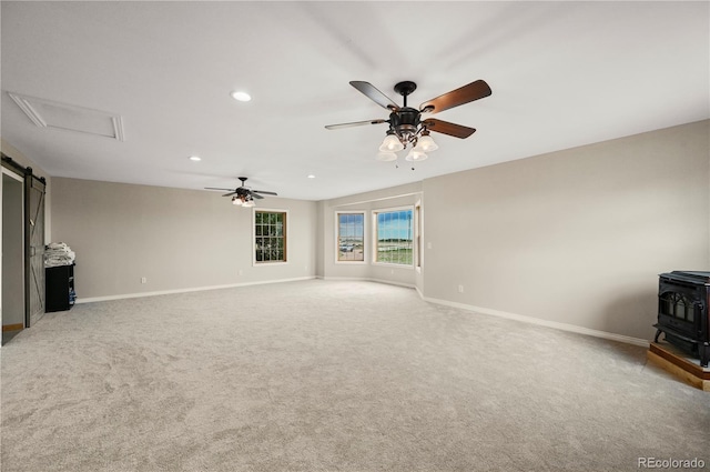 5520 Coyote Ln, Peyton, CO 80831 - unfurnished living room with a wood stove, a ceiling fan, carpet flooring, and recessed lighting