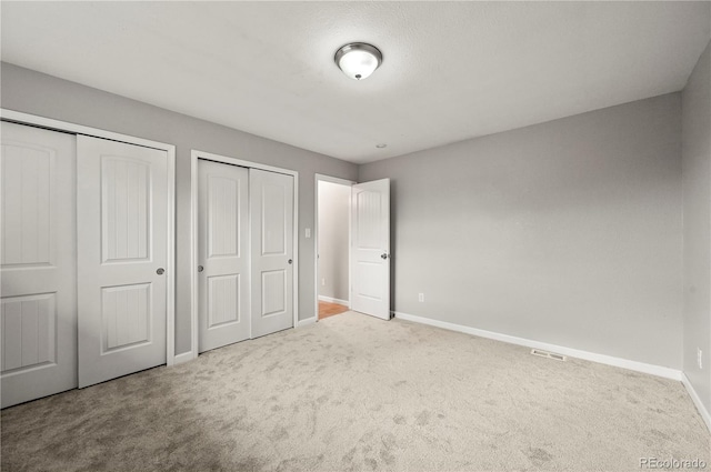5520 Coyote Ln, Peyton, CO 80831 - unfurnished bedroom with carpet floors and two closets