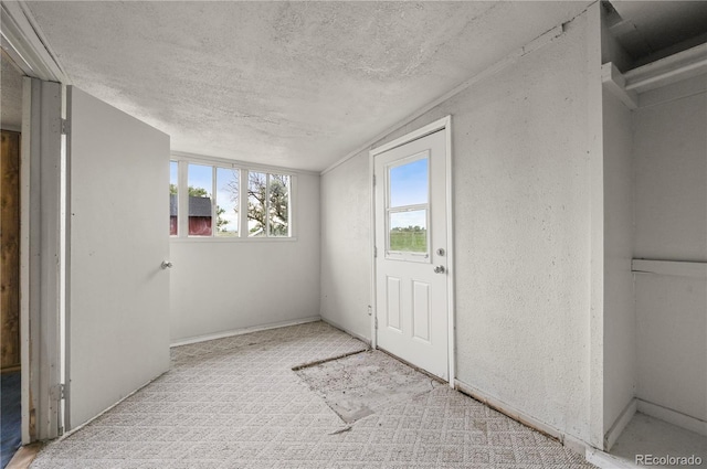 5520 Coyote Ln, Peyton, CO 80831 - entryway featuring a textured ceiling and carpet floors