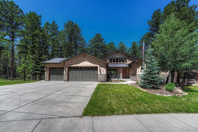 1250 Cottontail Trl, Woodland Park, CO 80863 - view of front of home with a garage, stone siding, driveway, and a front yard