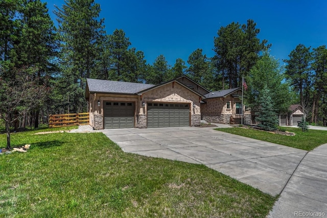 1250 Cottontail Trl, Woodland Park, CO 80863 - view of front of property featuring a garage, stone siding, and concrete driveway