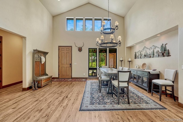 1250 Cottontail Trl, Woodland Park, CO 80863 - dining room featuring a chandelier, wood finished floors, and high vaulted ceiling