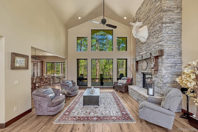 1250 Cottontail Trl, Woodland Park, CO 80863 - living area with a stone fireplace, wood finished floors, and high vaulted ceiling