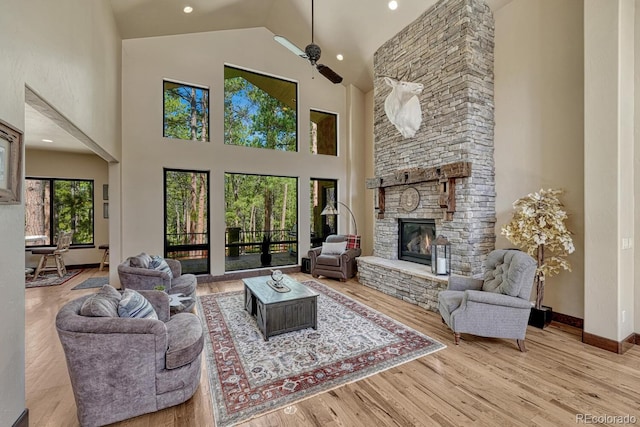 1250 Cottontail Trl, Woodland Park, CO 80863 - living room with a fireplace, wood finished floors, high vaulted ceiling, and a ceiling fan