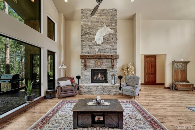 1250 Cottontail Trl, Woodland Park, CO 80863 - living room with a towering ceiling, wood finished floors, and a fireplace