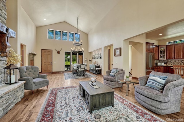 1250 Cottontail Trl, Woodland Park, CO 80863 - living room featuring a chandelier, light wood-style floors, and high vaulted ceiling