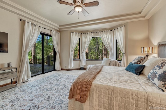 1250 Cottontail Trl, Woodland Park, CO 80863 - carpeted bedroom featuring a tray ceiling, access to exterior, and a ceiling fan