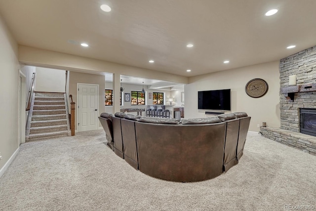 1250 Cottontail Trl, Woodland Park, CO 80863 - carpeted living room featuring recessed lighting, stairway, and a stone fireplace